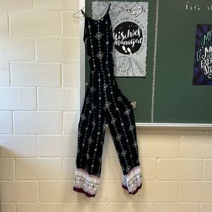 Black jumpsuit with white and maroon accents